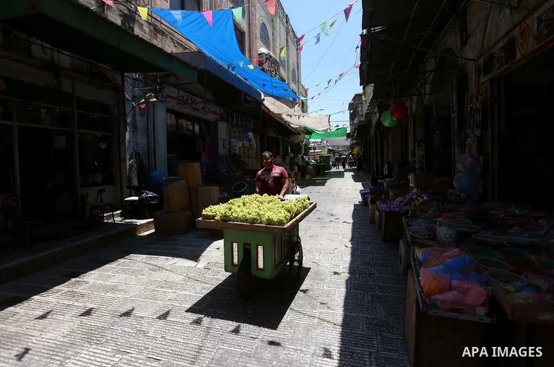A Palestinian vendor sells grapes at a market on the Muslim holy fasting month of Ramadan in the Old City of the West Bank town of Nablus, on June 13, 2017. Ramadan is sacred to Muslims because it is during that month th...
