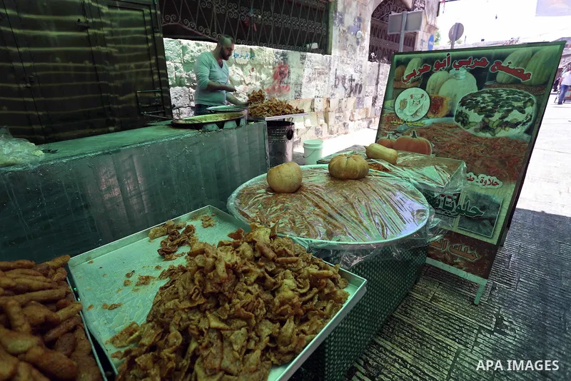 A Palestinian vendor preparers a traditional sweets at a market on the Muslim holy fasting month of Ramadan in the Old City of the West Bank town of Nablus, on June 13, 2017. Ramadan is sacred to Muslims because it is du...