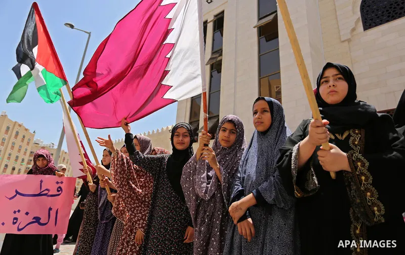 Palestinian women take part in a rally in support of Qatar, inside Qatari-funded construction project 'Hamad City', in Khan Younis in the southern Gaza Strip, June 14, 2017. Photo by Ashraf Amra