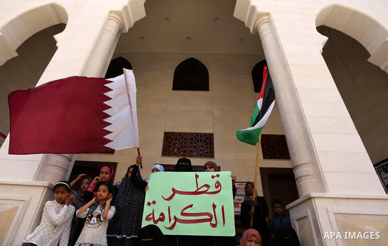 Palestinian women take part in a rally in support of Qatar, inside Qatari-funded construction project 'Hamad City', in Khan Younis in the southern Gaza Strip, June 14, 2017. Photo by Ashraf Amra