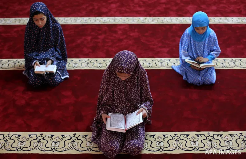 Palestinian girls read copies of the Koran, Islam's holiest book, on the Muslim holy fasting month of Ramadan, at Hamad Mosque in Khan Younis in the southern Gaza Strip, June 14, 2017. Ramadan is sacred to Muslims becaus...