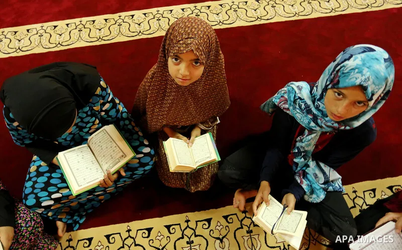 Palestinian girls attend a lesson of Koran, Islam's holiest book on the Muslim holy fasting month of Ramadan, at Hamad Mosque in Khan Younis in the southern Gaza Strip, June 14, 2017. Ramadan is sacred to Muslims because...