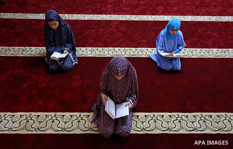 Palestinian girls read copies of the Koran, Islam's holiest book, on the Muslim holy fasting month of Ramadan, at Hamad Mosque in Khan Younis in the southern Gaza Strip, June 14, 2017. Ramadan is sacred to Muslims becaus...