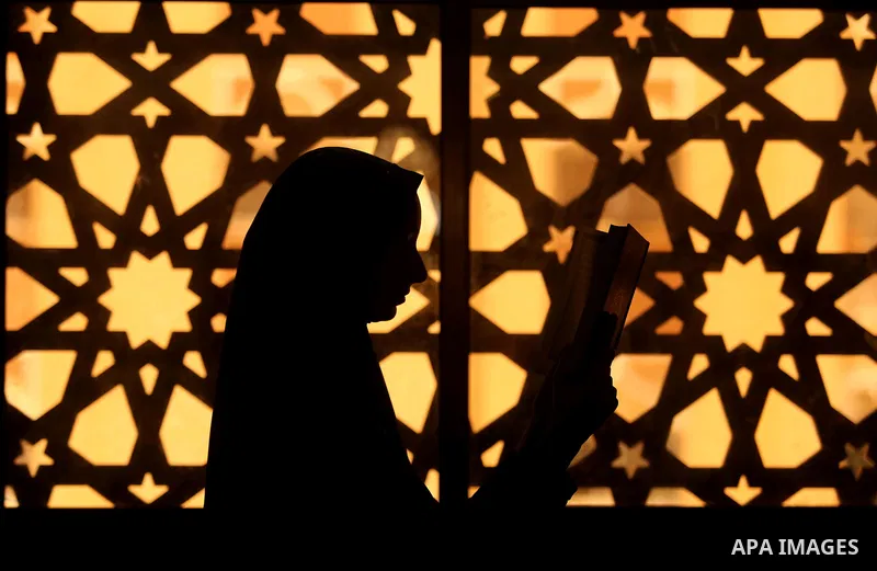 A Palestinian girl holds a copy of the Koran, Islam's holiest book, on the Muslim holy fasting month of Ramadan, at Hamad Mosque in Khan Younis in the southern Gaza Strip, June 14, 2017. Ramadan is sacred to Muslims beca...