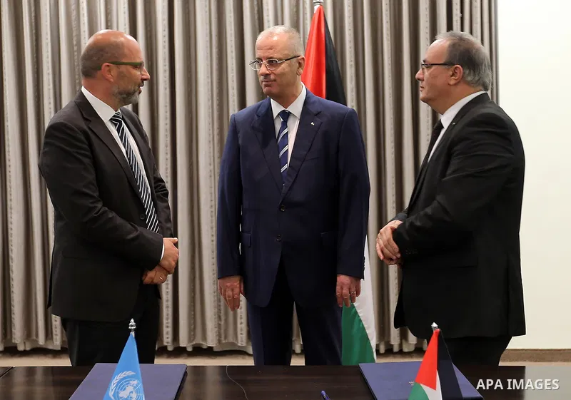 Palestinian Prime Minister Rami Hamdallah attends signing an agreement with United Nation, in the West Bank city of Ramallah on June 15, 2017. Photo by Prime Minister Office