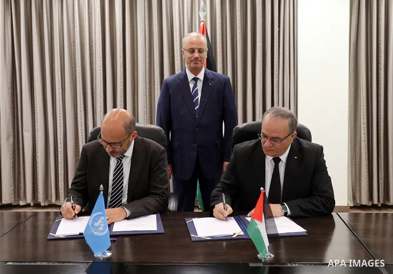 Palestinian Prime Minister Rami Hamdallah attends signing an agreement with United Nation, in the West Bank city of Ramallah on June 15, 2017. Photo by Prime Minister Office
