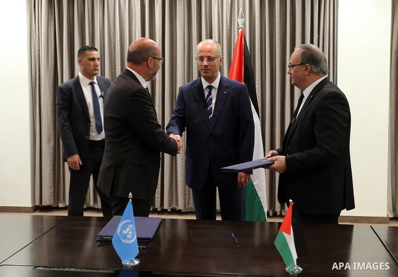 Palestinian Prime Minister Rami Hamdallah attends signing an agreement with United Nation, in the West Bank city of Ramallah on June 15, 2017. Photo by Prime Minister Office