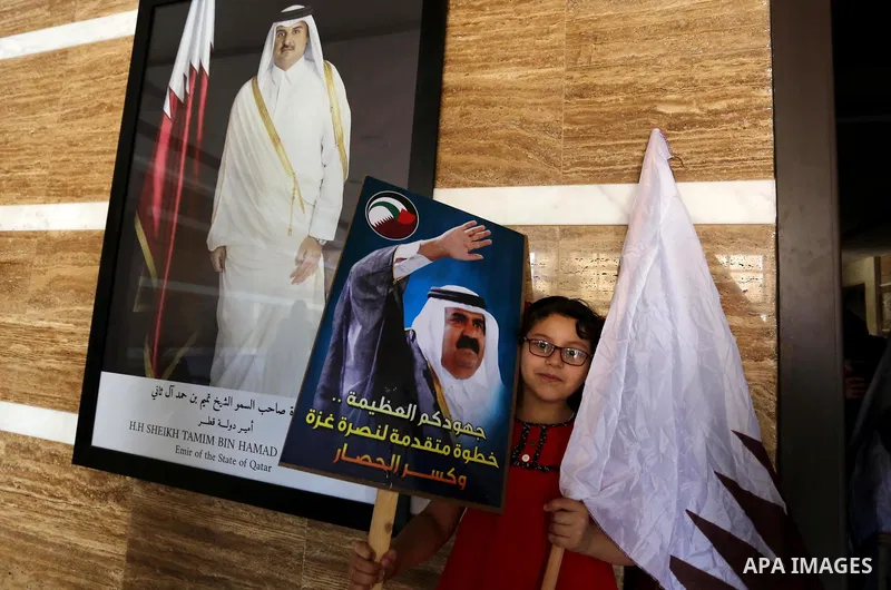 Palestinians take part in a rally in support of Qatar, inside a hospital funded by Qatar in Gaza City, on June 15, 2017. Photo by Ashraf Amra