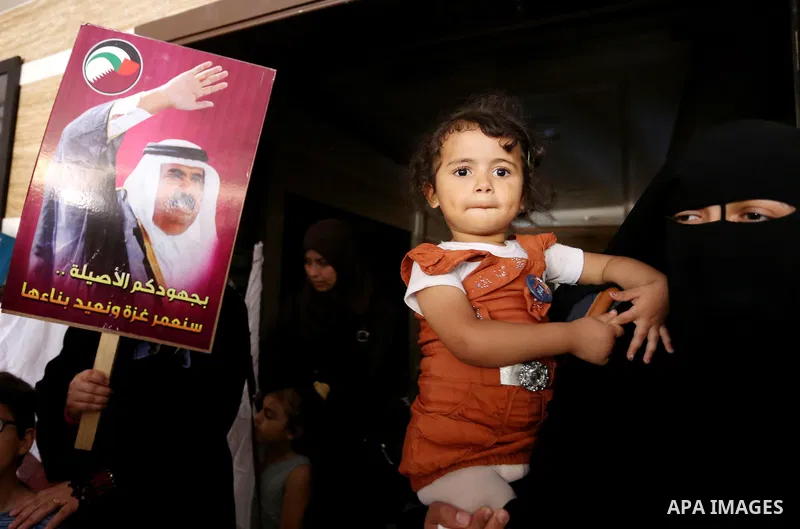 Palestinians take part in a rally in support of Qatar, inside a hospital funded by Qatar in Gaza City, on June 15, 2017. Photo by Ashraf Amra