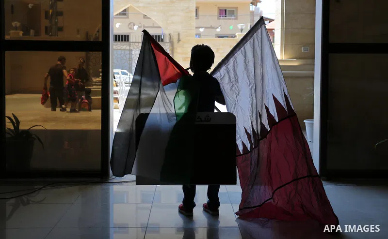 Palestinians take part in a rally in support of Qatar, inside a hospital funded by Qatar in Gaza City, on June 15, 2017. Photo by Ashraf Amra