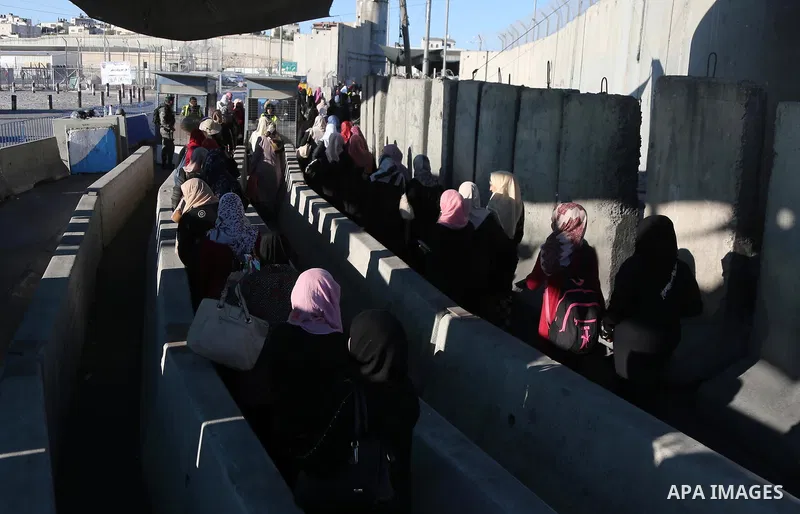 Palestinians make their way through the Israeli Qalandia checkpoint, in the occupied West Bank between Ramallah and Jerusalem, to attend Friday prayer of the holy fasting month of Ramadan in Jerusalem's al-Aqsa mosque, o...