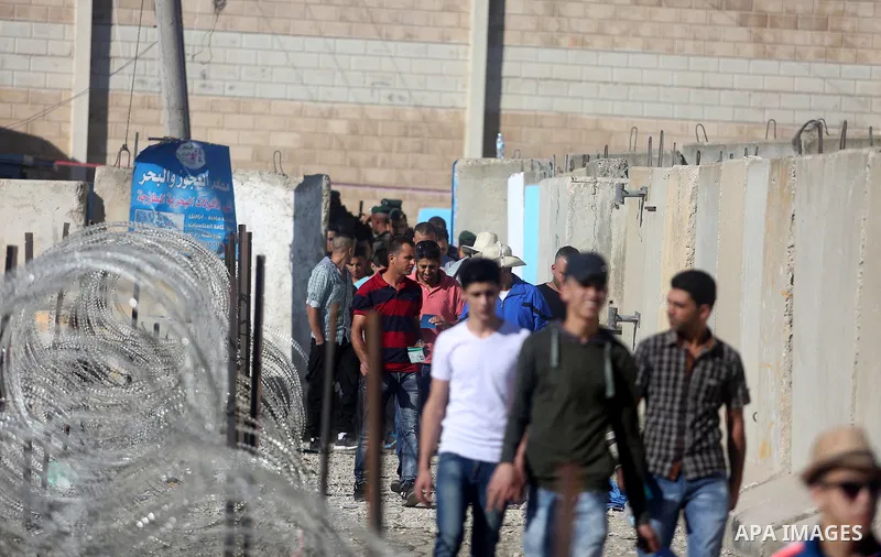 Palestinians make their way through the Israeli Qalandia checkpoint, in the occupied West Bank between Ramallah and Jerusalem, to attend Friday prayer of the holy fasting month of Ramadan in Jerusalem's al-Aqsa mosque, o...