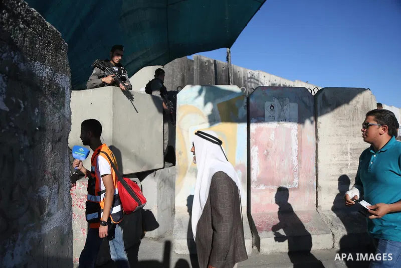 Palestinians make their way through the Israeli Qalandia checkpoint, in the occupied West Bank between Ramallah and Jerusalem, to attend Friday prayer of the holy fasting month of Ramadan in Jerusalem's al-Aqsa mosque, o...