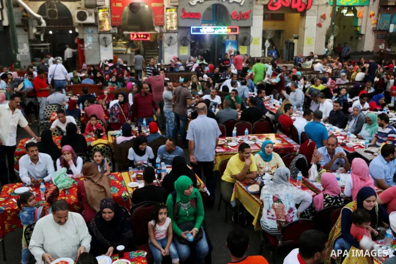 Egyptian muslims take their breakfast during the holy fasting month of Ramadan in front of al-Hussein mosque at Al-Azhar district in old Islamic Cairo, Egypt, on June 17, 2017. Ramadan is sacred to Muslims because it is...