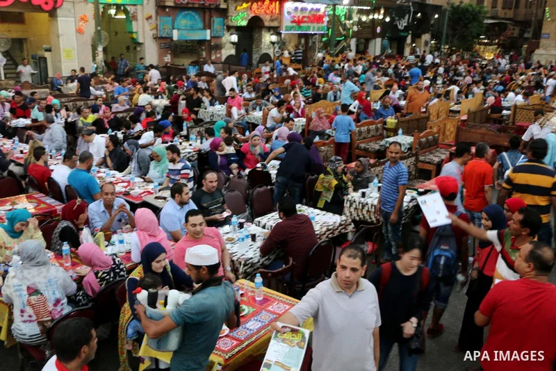 Egyptian muslims take their breakfast during the holy fasting month of Ramadan in front of al-Hussein mosque at Al-Azhar district in old Islamic Cairo, Egypt, on June 17, 2017. Ramadan is sacred to Muslims because it is...