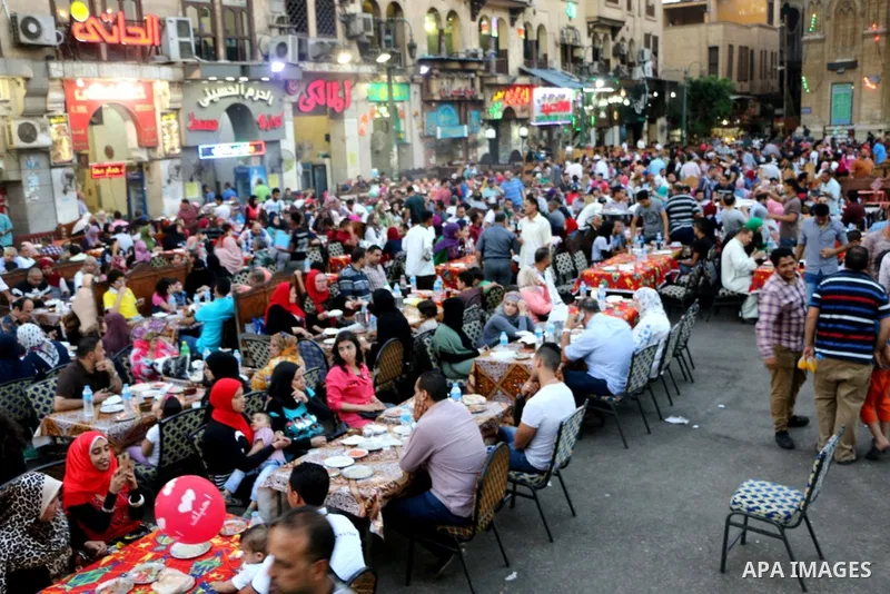Egyptian muslims take their breakfast during the holy fasting month of Ramadan in front of al-Hussein mosque at Al-Azhar district in old Islamic Cairo, Egypt, on June 17, 2017. Ramadan is sacred to Muslims because it is...