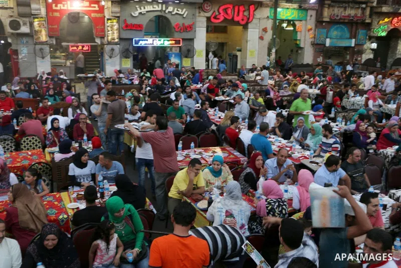 Egyptian muslims take their breakfast during the holy fasting month of Ramadan in front of al-Hussein mosque at Al-Azhar district in old Islamic Cairo, Egypt, on June 17, 2017. Ramadan is sacred to Muslims because it is...