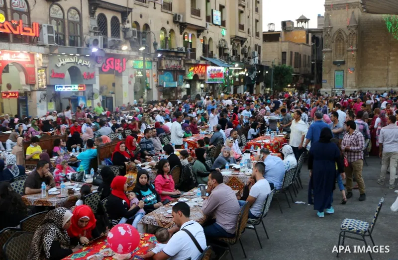 Egyptian muslims take their breakfast during the holy fasting month of Ramadan in front of al-Hussein mosque at Al-Azhar district in old Islamic Cairo, Egypt, on June 17, 2017. Ramadan is sacred to Muslims because it is...