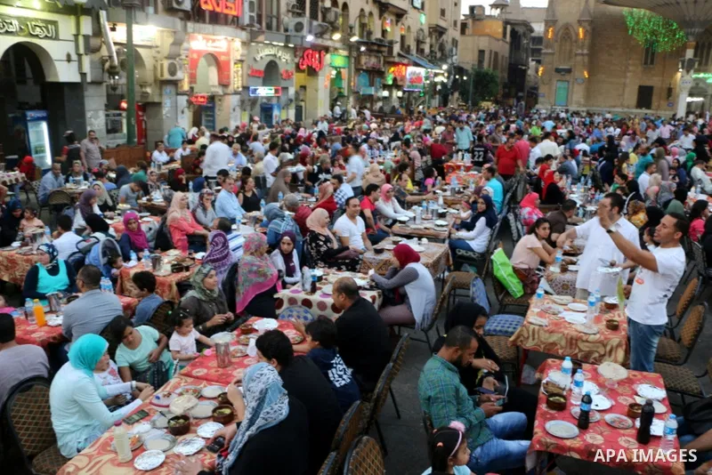 Egyptian muslims take their breakfast during the holy fasting month of Ramadan in front of al-Hussein mosque at Al-Azhar district in old Islamic Cairo, Egypt, on June 17, 2017. Ramadan is sacred to Muslims because it is...