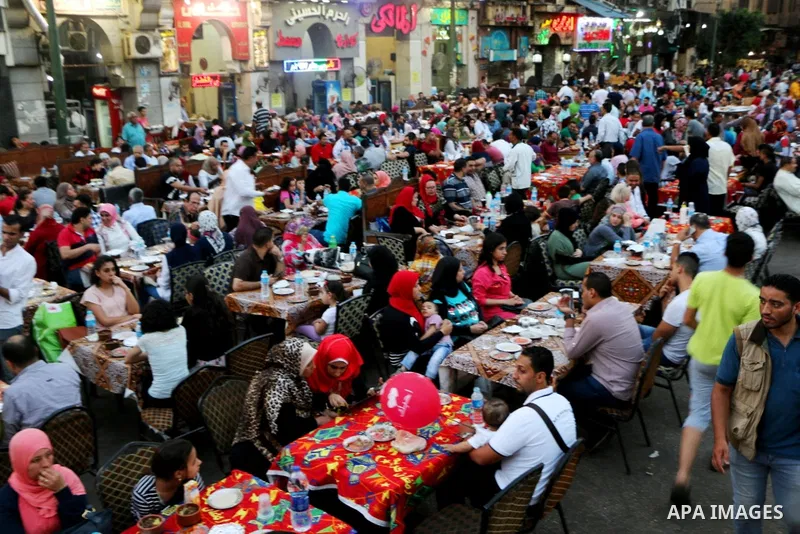 Egyptian muslims take their breakfast during the holy fasting month of Ramadan in front of al-Hussein mosque at Al-Azhar district in old Islamic Cairo, Egypt, on June 17, 2017. Ramadan is sacred to Muslims because it is...