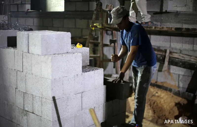A Palestinian labourer works at construction site at night, to avoid the day time heat, on the Muslim holy fasting month of Ramadan in Gaza city on June 17, 2017. Ramadan is sacred to Muslims because it is during that mo...