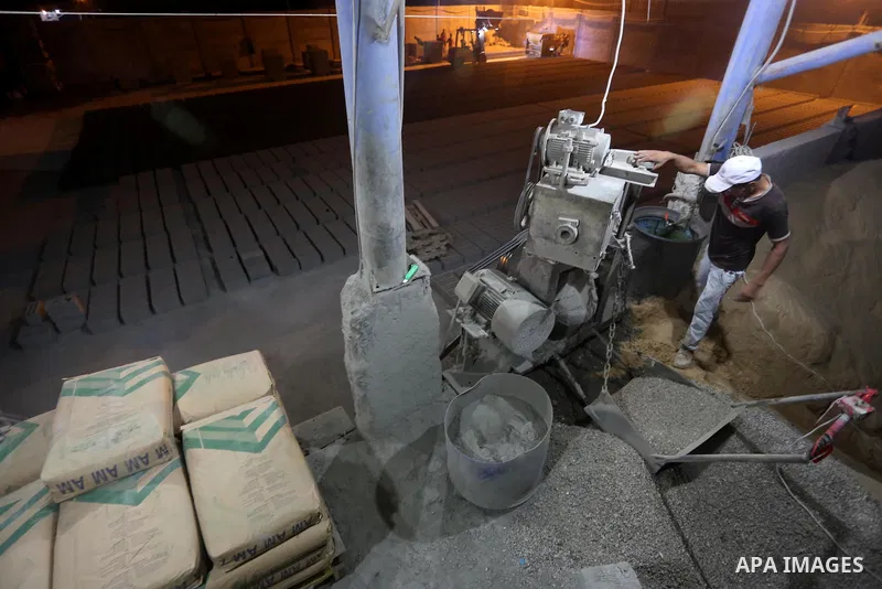 A Palestinian labourer works at a cement factory at night, to avoid the day time heat, on the Muslim holy fasting month of Ramadan in Gaza city on June 17, 2017. Ramadan is sacred to Muslims because it is during that mon...