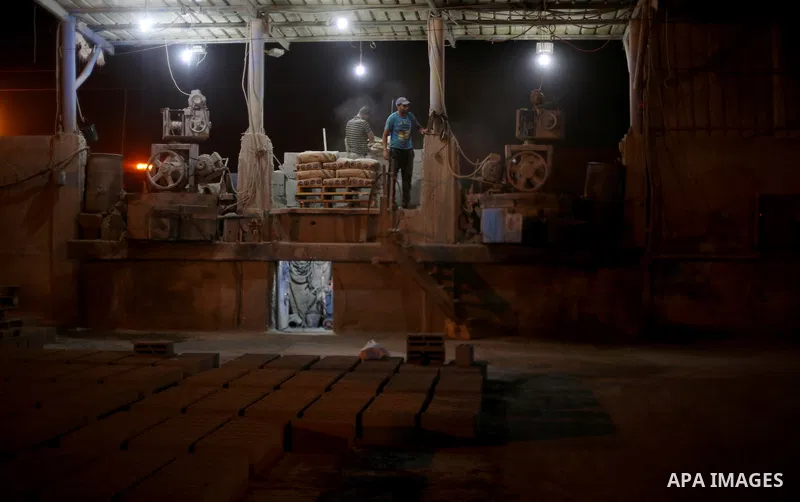 Palestinian labourers work at a cement factory at night, to avoid the day time heat, on the Muslim holy fasting month of Ramadan in Gaza city on June 17, 2017. Ramadan is sacred to Muslims because it is during that month...