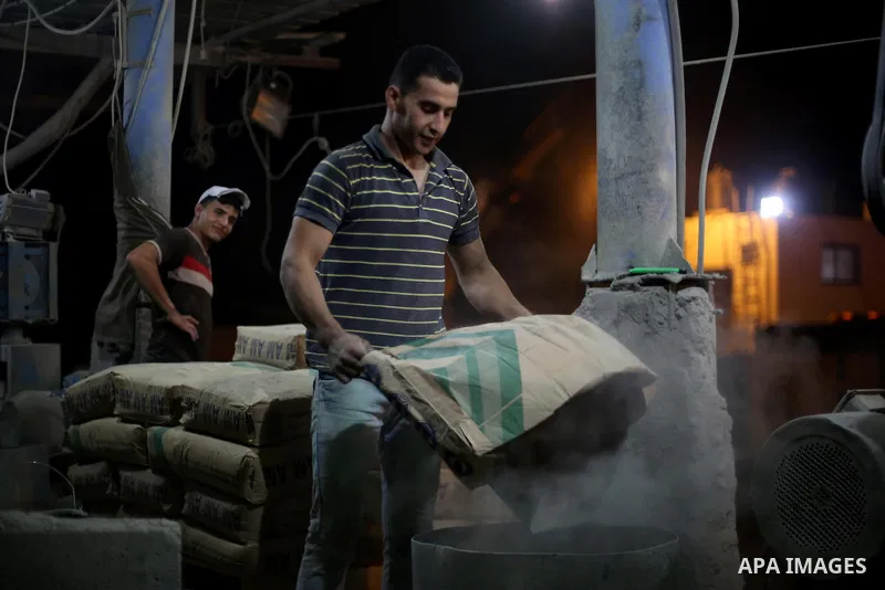 Palestinian labourers work at a cement factory at night, to avoid the day time heat, on the Muslim holy fasting month of Ramadan in Gaza city on June 17, 2017. Ramadan is sacred to Muslims because it is during that month...