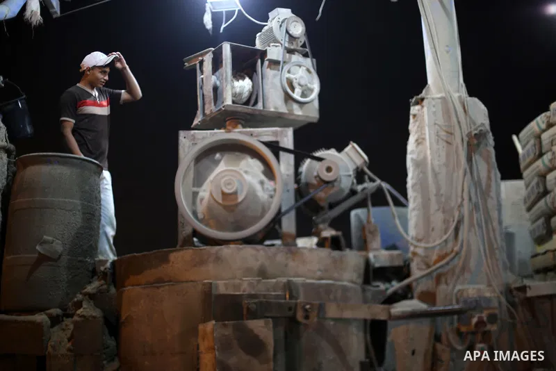 A Palestinian labourer works at a cement factory at night, to avoid the day time heat, on the Muslim holy fasting month of Ramadan in Gaza city on June 17, 2017. Ramadan is sacred to Muslims because it is during that mon...