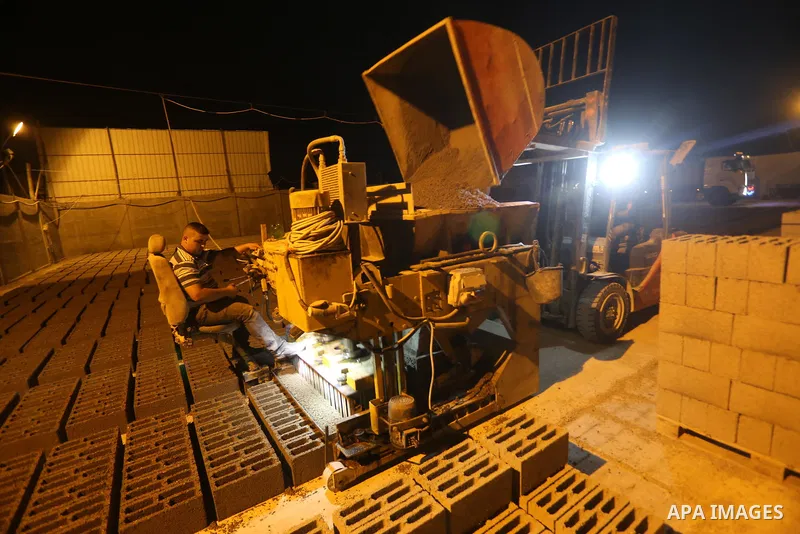 A Palestinian labourer works at a cement factory at night, to avoid the day time heat, on the Muslim holy fasting month of Ramadan in Gaza city on June 17, 2017. Ramadan is sacred to Muslims because it is during that mon...