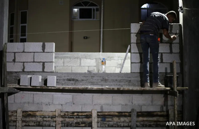 A Palestinian labourer works at construction site at night, to avoid the day time heat, on the Muslim holy fasting month of Ramadan in Gaza city on June 17, 2017. Ramadan is sacred to Muslims because it is during that mo...