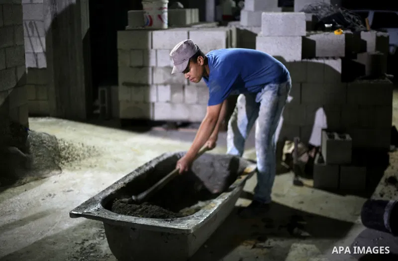A Palestinian labourer works at construction site at night, to avoid the day time heat, on the Muslim holy fasting month of Ramadan in Gaza city on June 17, 2017. Ramadan is sacred to Muslims because it is during that mo...