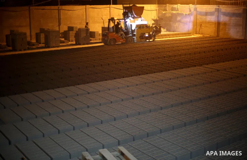 Palestinian labourers work at a cement factory at night, to avoid the day time heat, on the Muslim holy fasting month of Ramadan in Gaza city on June 17, 2017. Ramadan is sacred to Muslims because it is during that month...