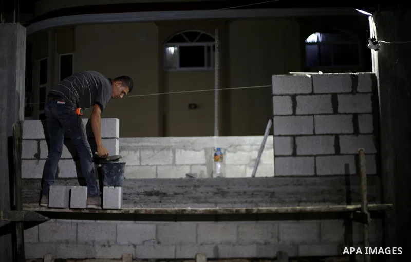 A Palestinian labourer works at construction site at night, to avoid the day time heat, on the Muslim holy fasting month of Ramadan in Gaza city on June 17, 2017. Ramadan is sacred to Muslims because it is during that mo...