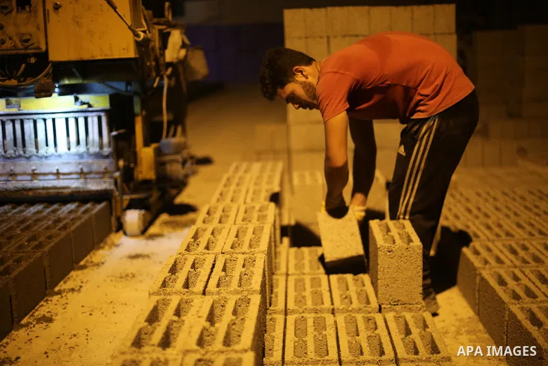 A Palestinian labourer works at a cement factory at night, to avoid the day time heat, on the Muslim holy fasting month of Ramadan in Gaza city on June 17, 2017. Ramadan is sacred to Muslims because it is during that mon...