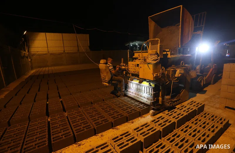 A Palestinian labourer works at a cement factory at night, to avoid the day time heat, on the Muslim holy fasting month of Ramadan in Gaza city on June 17, 2017. Ramadan is sacred to Muslims because it is during that mon...