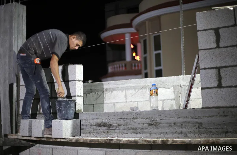 A Palestinian labourer works at construction site at night, to avoid the day time heat, on the Muslim holy fasting month of Ramadan in Gaza city on June 17, 2017. Ramadan is sacred to Muslims because it is during that mo...