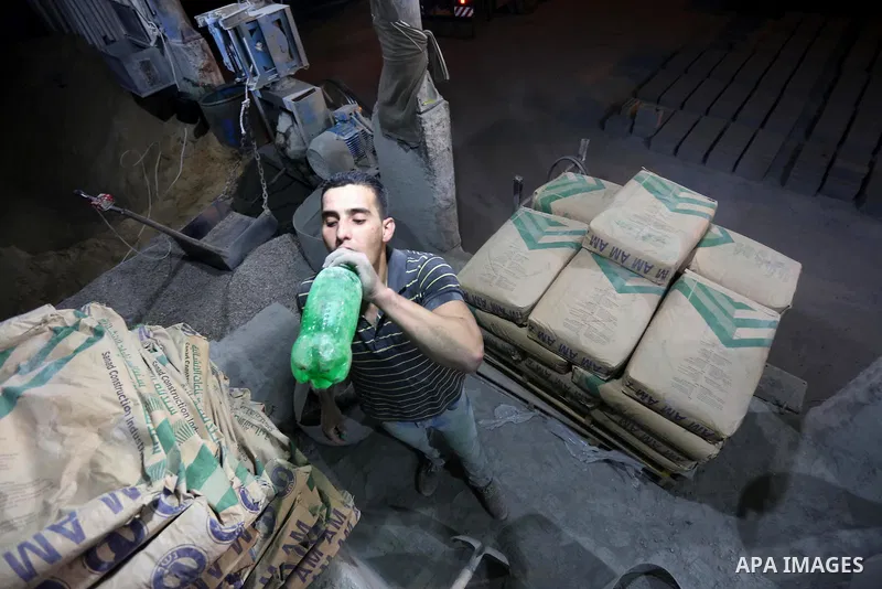 A Palestinian labourer works at a cement factory at night, to avoid the day time heat, on the Muslim holy fasting month of Ramadan in Gaza city on June 17, 2017. Ramadan is sacred to Muslims because it is during that mon...