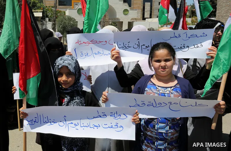 Palestinian women take part in a rally in support of Qatar and against the blockade on the Gaza Strip, in front of the Legislative Council in Gaza city on June 18, 2017. Photo by Ashraf Amra