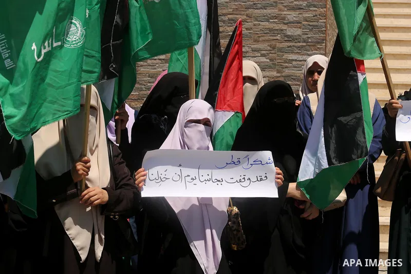 Palestinian women take part in a rally in support of Qatar and against the blockade on the Gaza Strip, in front of the Legislative Council in Gaza city on June 18, 2017. Photo by Ashraf Amra