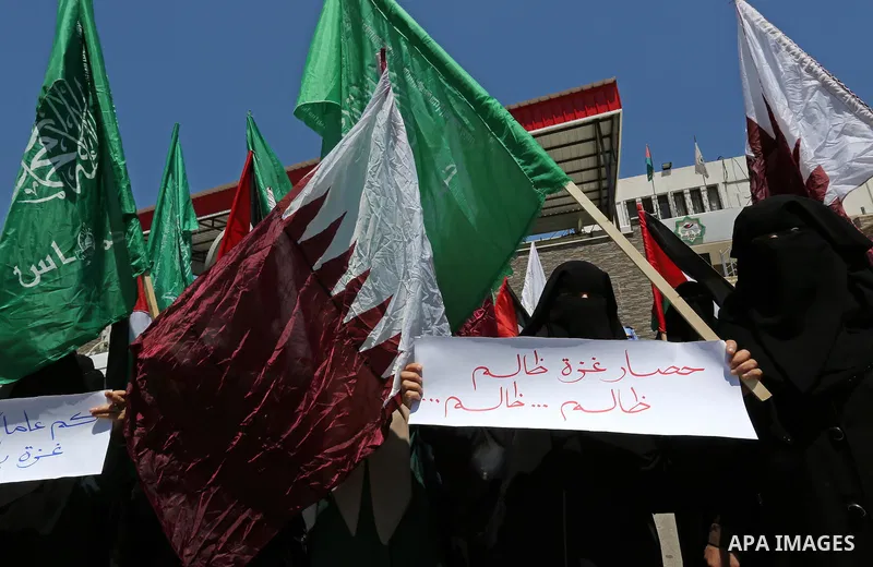 Palestinian women take part in a rally in support of Qatar and against the blockade on the Gaza Strip, in front of the Legislative Council in Gaza city on June 18, 2017. Photo by Ashraf Amra