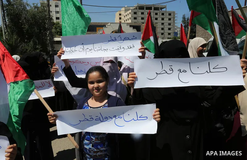 Palestinian women take part in a rally in support of Qatar and against the blockade on the Gaza Strip, in front of the Legislative Council in Gaza city on June 18, 2017. Photo by Ashraf Amra