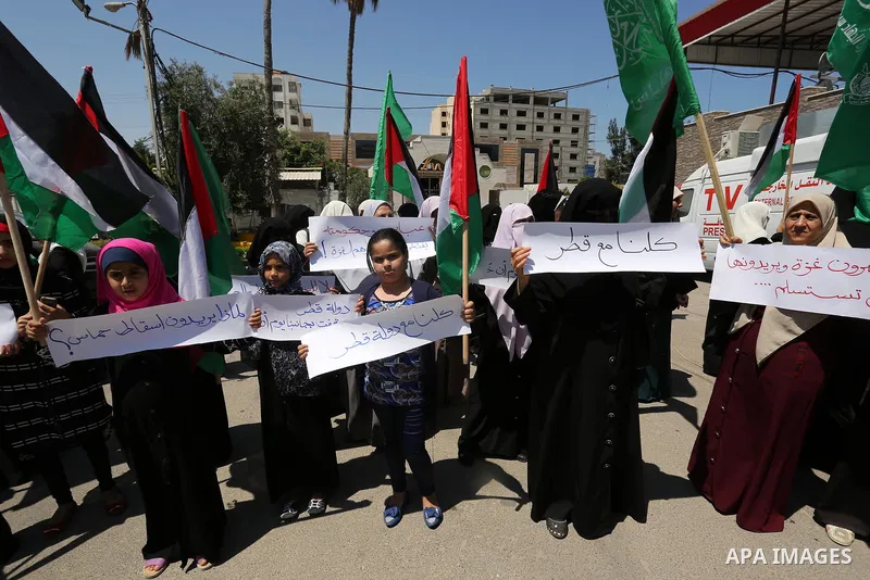 Palestinian women take part in a rally in support of Qatar and against the blockade on the Gaza Strip, in front of the Legislative Council in Gaza city on June 18, 2017. Photo by Ashraf Amra