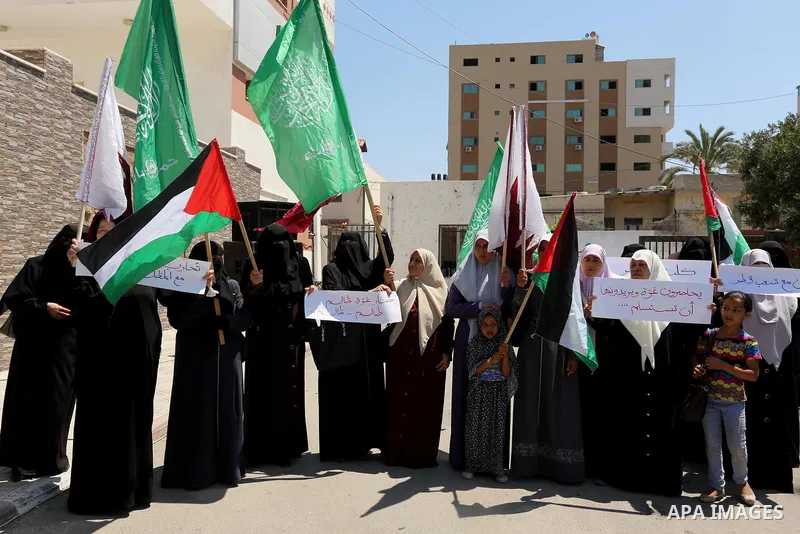 Palestinian women take part in a rally in support of Qatar and against the blockade on the Gaza Strip, in front of the Legislative Council in Gaza city on June 18, 2017. Photo by Ashraf Amra