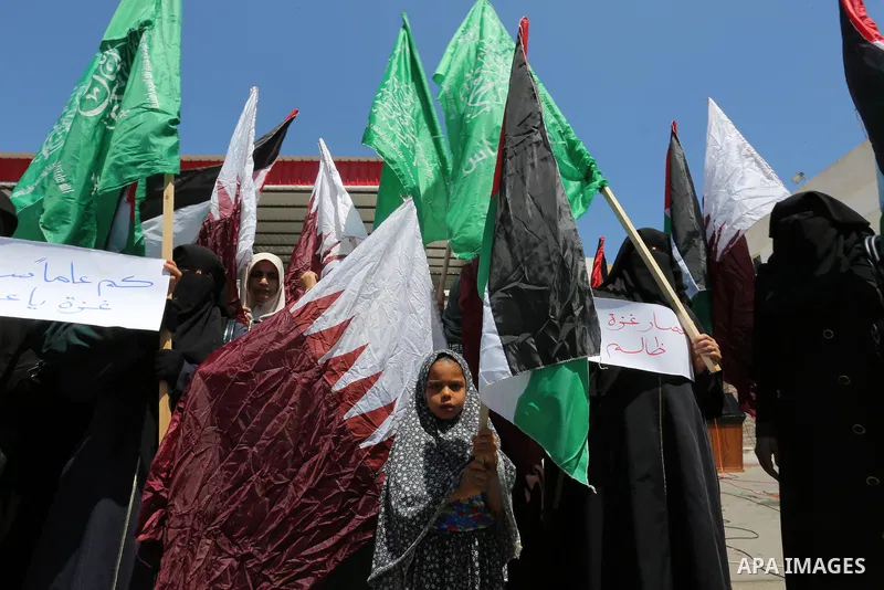 Palestinian women take part in a rally in support of Qatar and against the blockade on the Gaza Strip, in front of the Legislative Council in Gaza city on June 18, 2017. Photo by Ashraf Amra