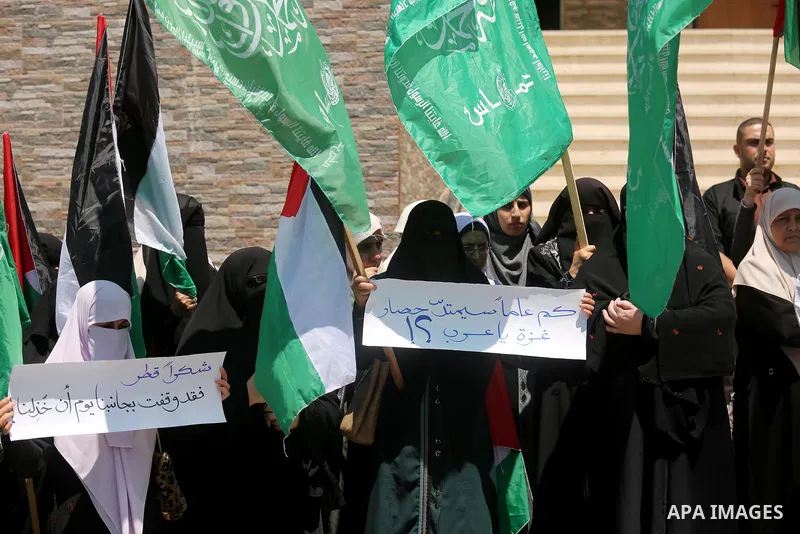 Palestinian women take part in a rally in support of Qatar and against the blockade on the Gaza Strip, in front of the Legislative Council in Gaza city on June 18, 2017. Photo by Ashraf Amra