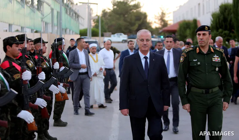 Palestinian Prime Minister Rami Hamdallah reviews the honor guards as he arrives to breakfasting with security forces on the Muslim holy fasting month of Ramadan, in the West Bank city of Jenin on June 18, 2017. Photo by...