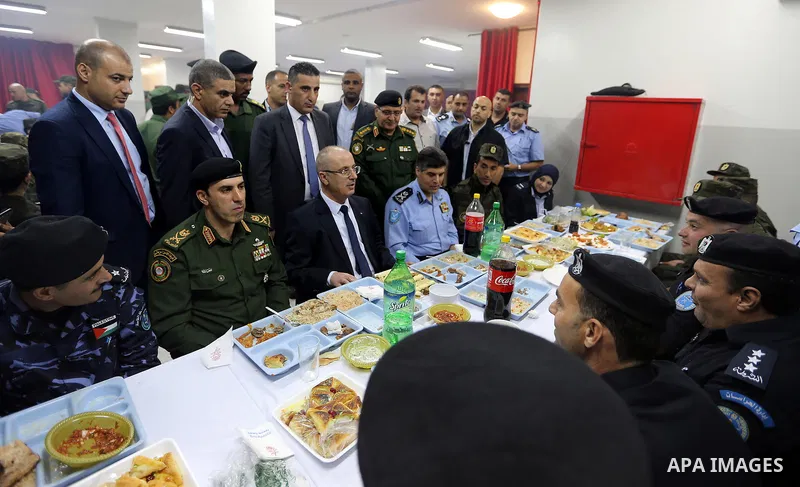 Palestinian Prime Minister Rami Hamdallah takes part in breakfast with security forces on the Muslim holy fasting month of Ramadan, in the West Bank city of Jenin on June 18, 2017. Photo by Prime Minister Office