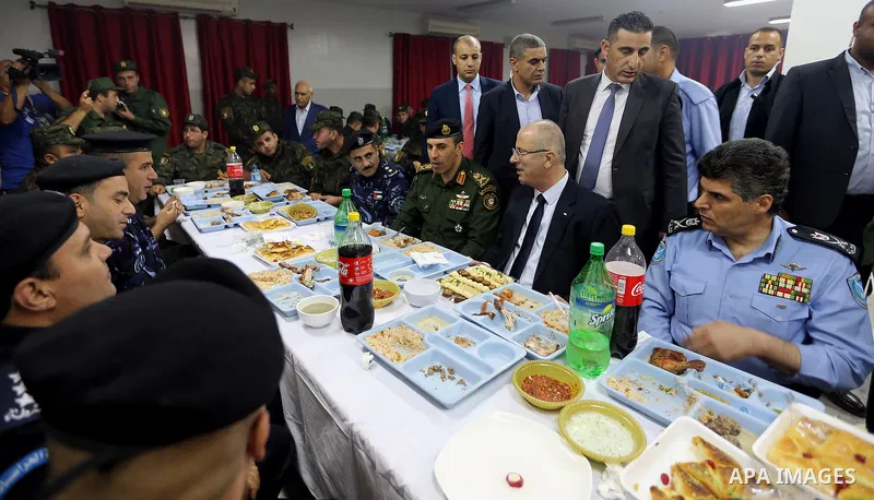 Palestinian Prime Minister Rami Hamdallah takes part in breakfast with security forces on the Muslim holy fasting month of Ramadan, in the West Bank city of Jenin on June 18, 2017. Photo by Prime Minister Office