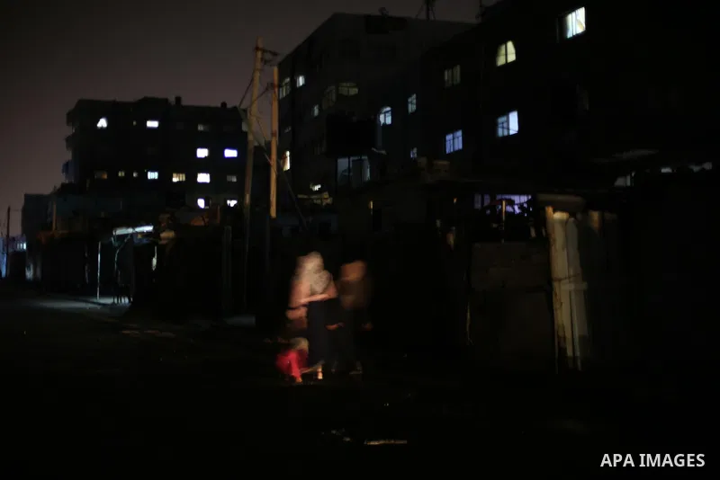 A general view shows Gaza City in the evening hours during a power cut, on June 19, 2017. Photo by Mohammed Asad
